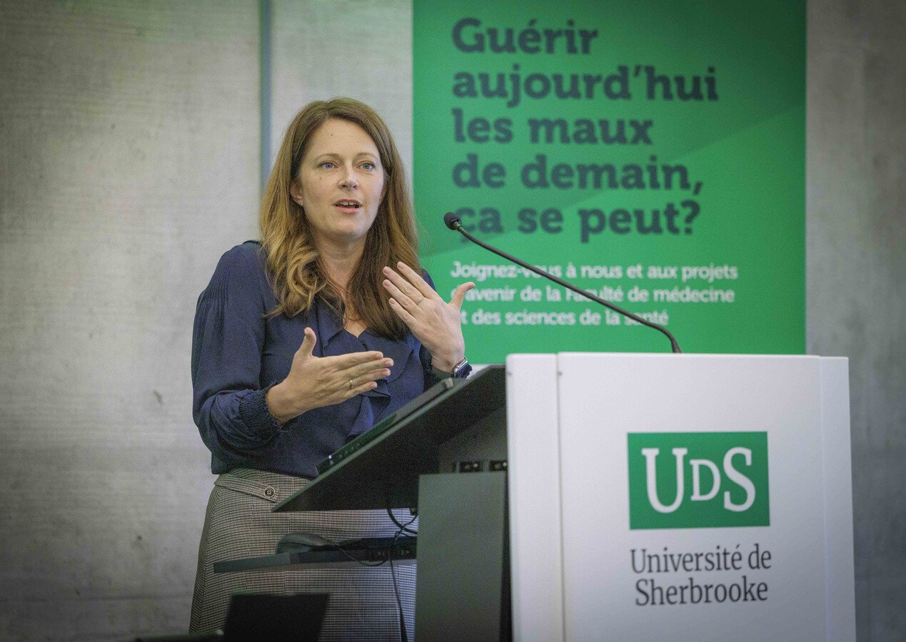 Une femme derrière un lutrin prononçant un discours 