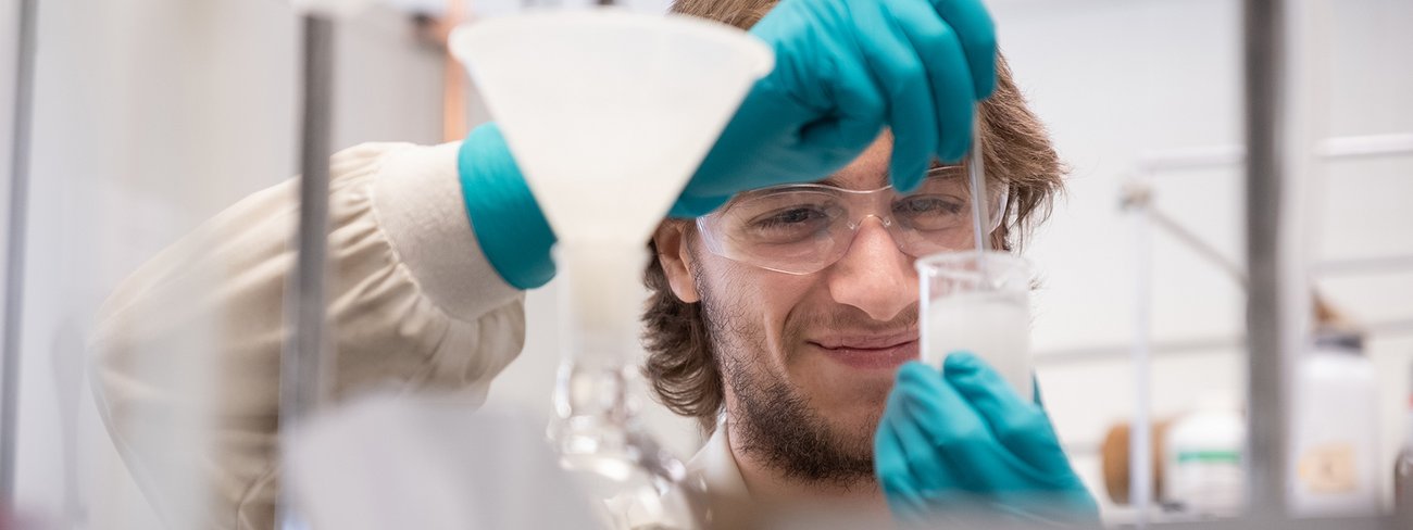 Personne étudiante en expérimentation dans un laboratoire du Département de chimie