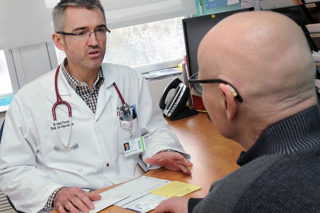 Photo of a doctor talking with one of his patients.