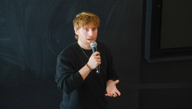 Photo d'Arsène Guédon présentant son projet de thèse de doctorat.