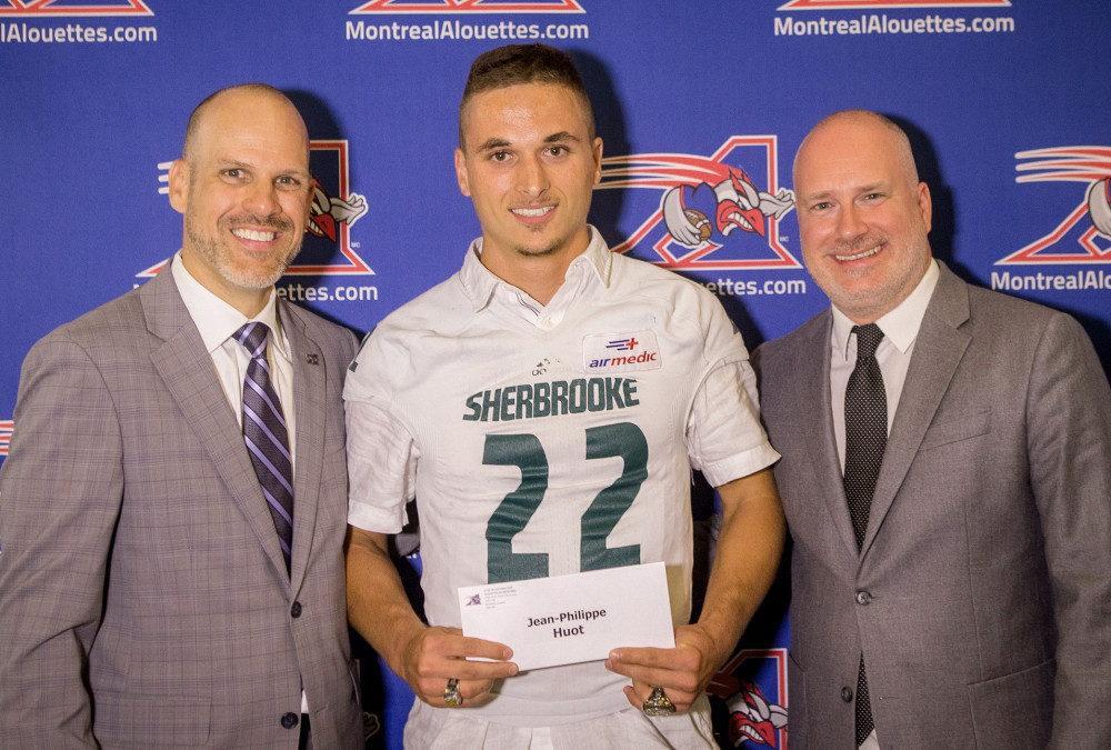 Jean-Philippe Huot re&ccedil;oit sa bourse de Mark Weightman des Alouettes de Montr&eacute;al et de Simon C&eacute;r&eacute;des Cha&icirc;nes francophones Bell M&eacute;dia.