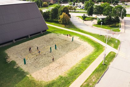 Des étudiants jouent sur le terrain de volleyball extérieur au Centre sportif du Campus principal