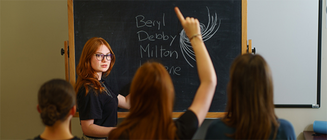 Étudiants et étudiants devant un tableau noir